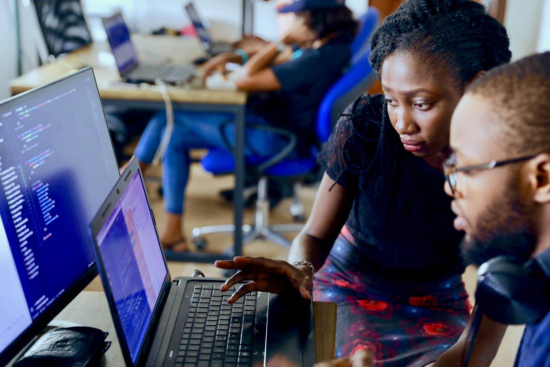 Engineers reviewing work together on a laptop