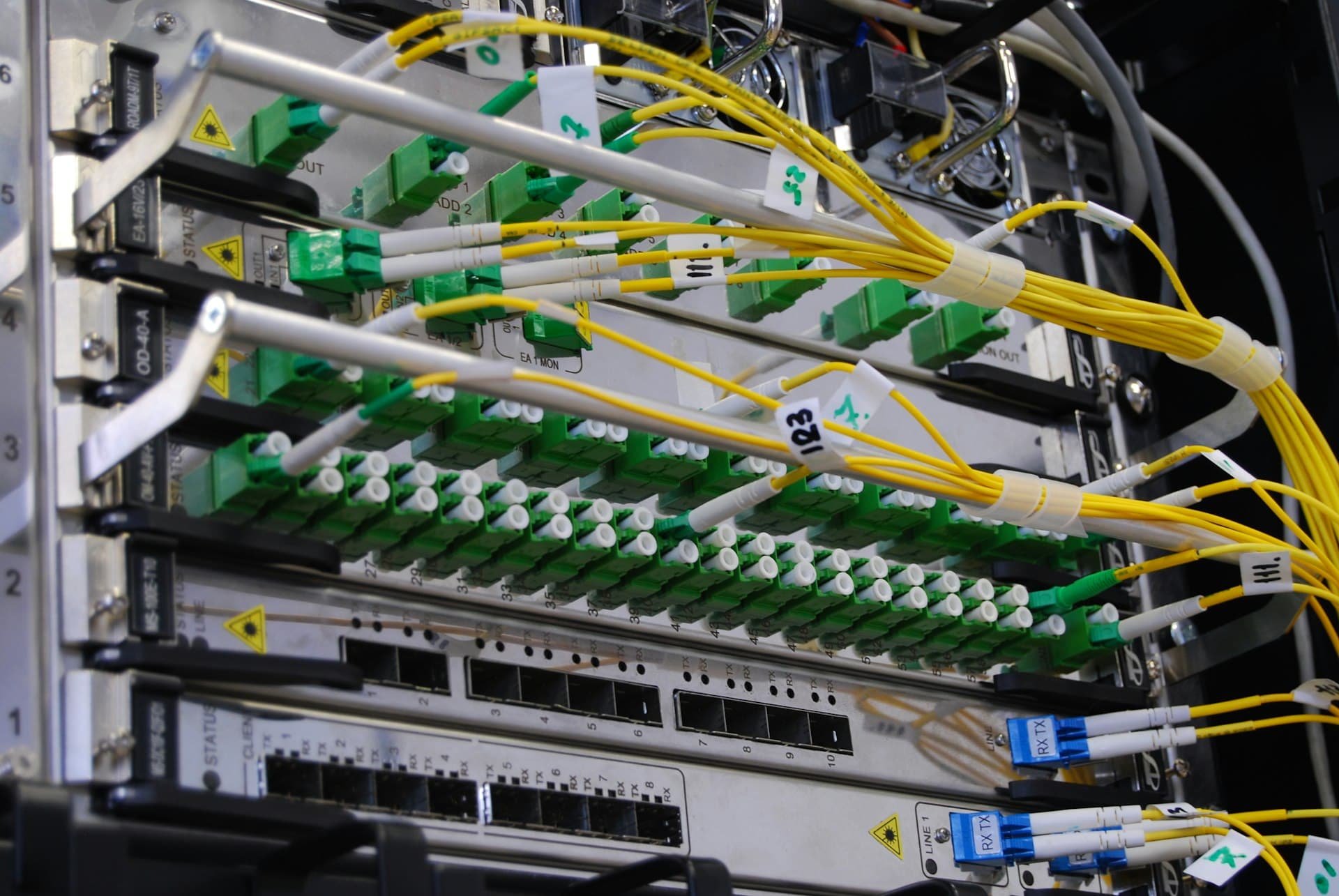 Fibre optic cables connected to a network switch in a server rack